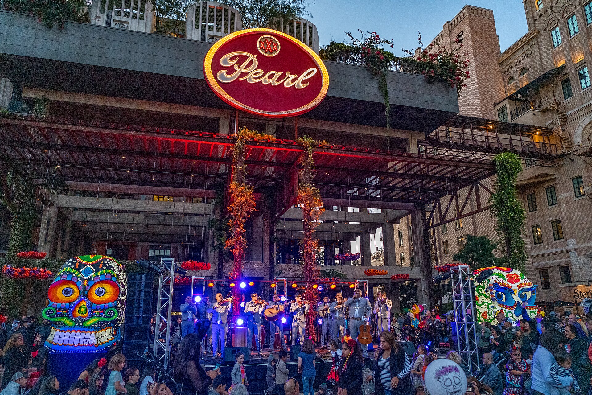 The illuminated Pearl sign above the plaza during the district's Día de los Muertos celebration